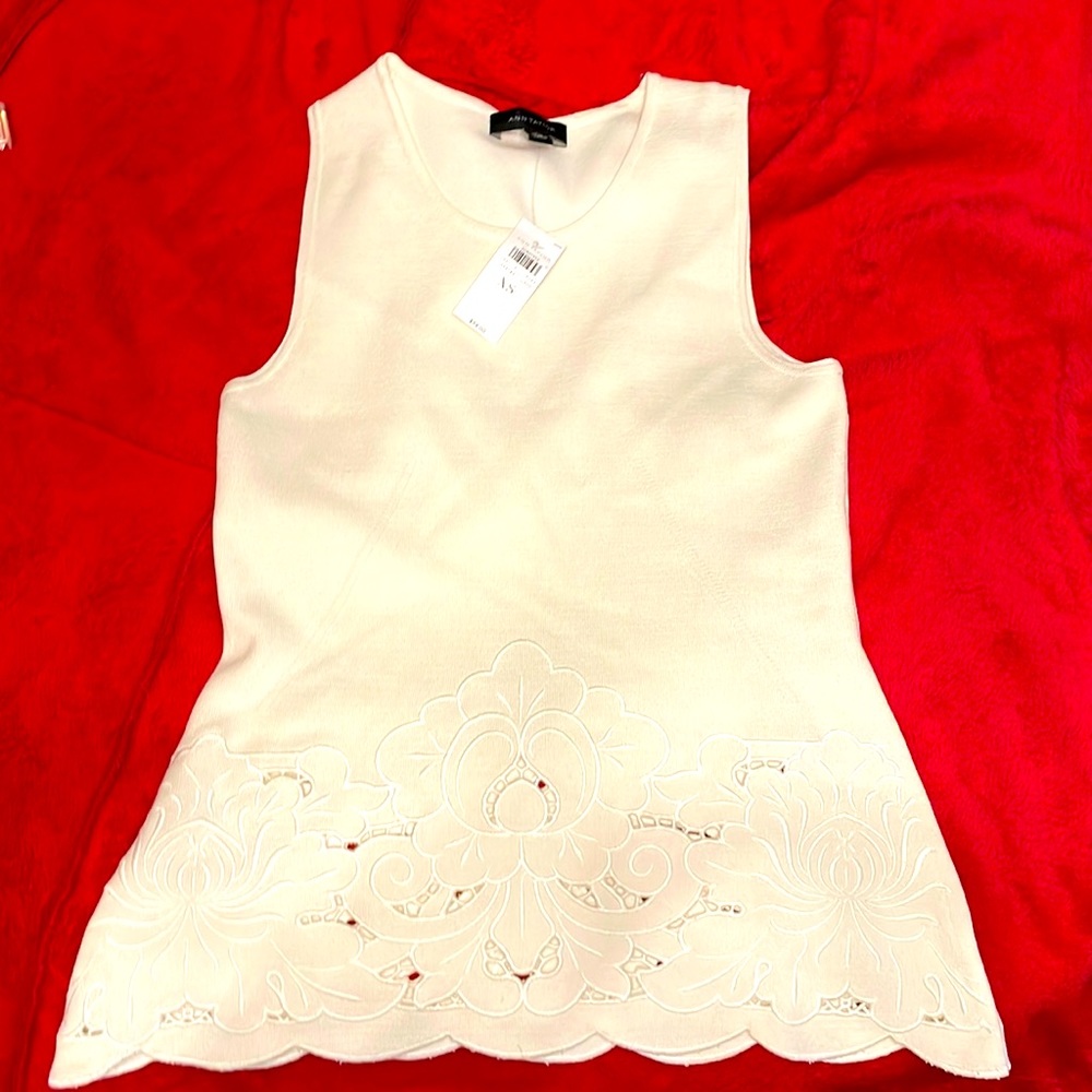 Ann Taylor flared knit top with cut out an embroidered trim on bottom